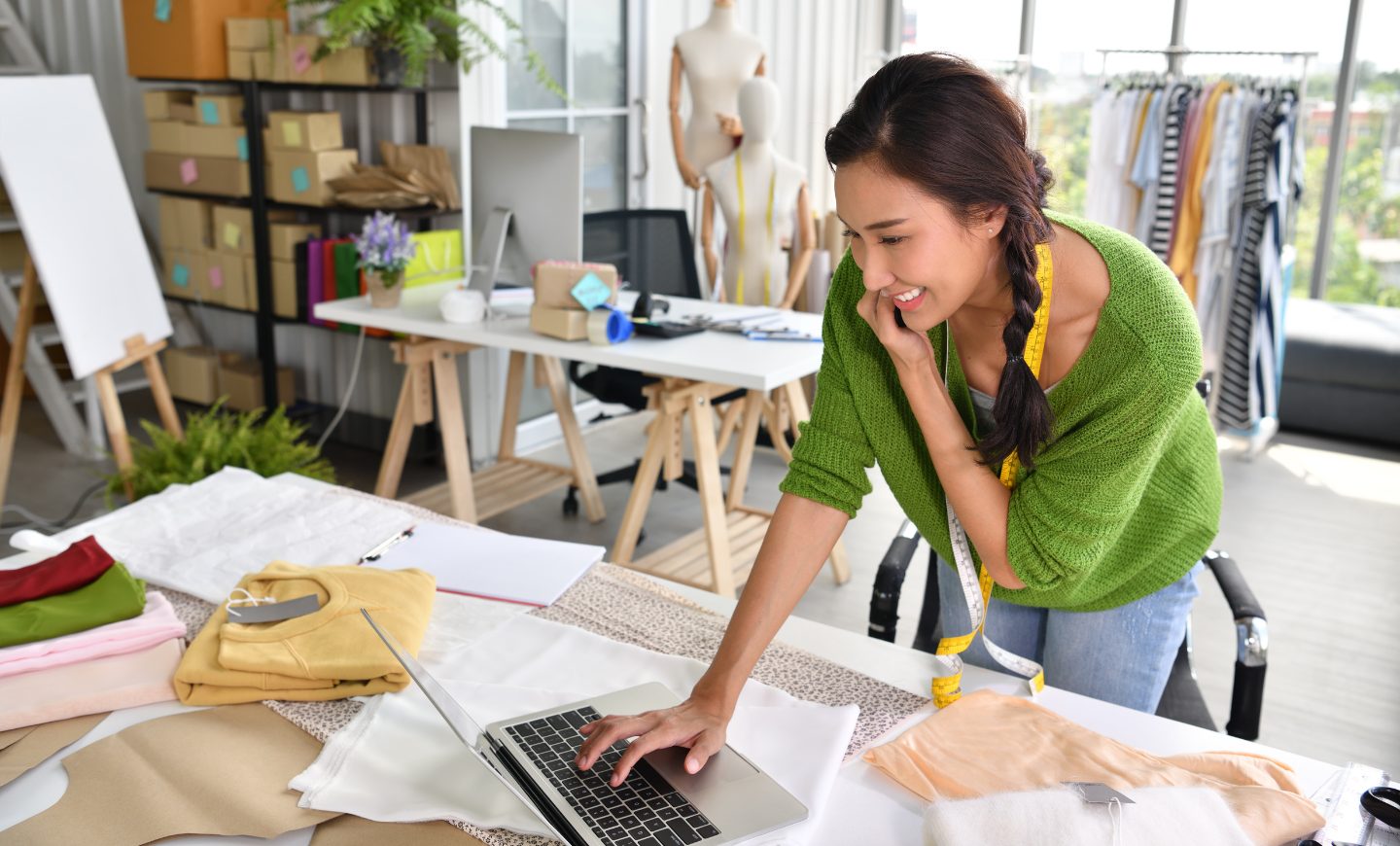 A business owner working at a laptop in her studio